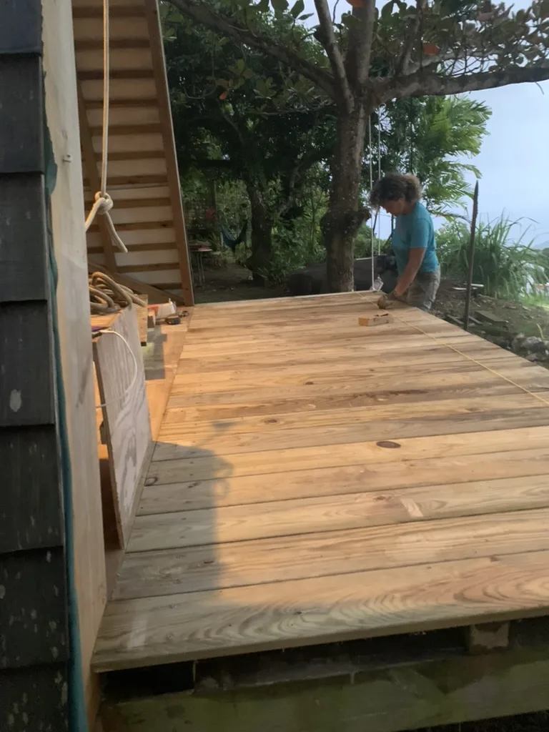 Laying the deck with greenery and the sea behind