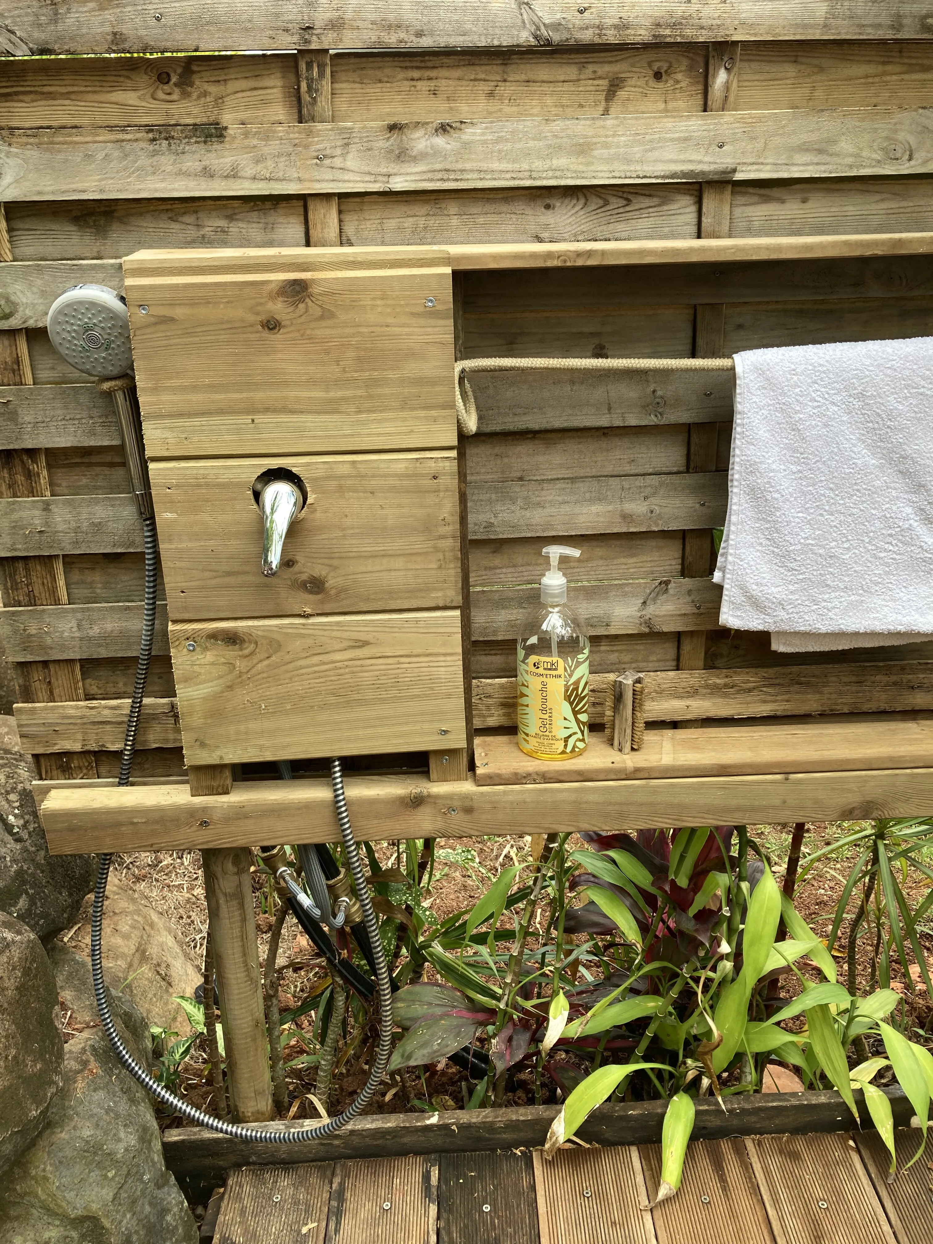 Douche extérieure en bois dans le jardin tropical, Les Vendredis